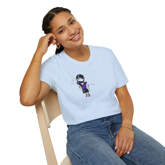 Woman wearing a light blue t-shirt with a lady ninja graphic design, sitting on a chair against a white background