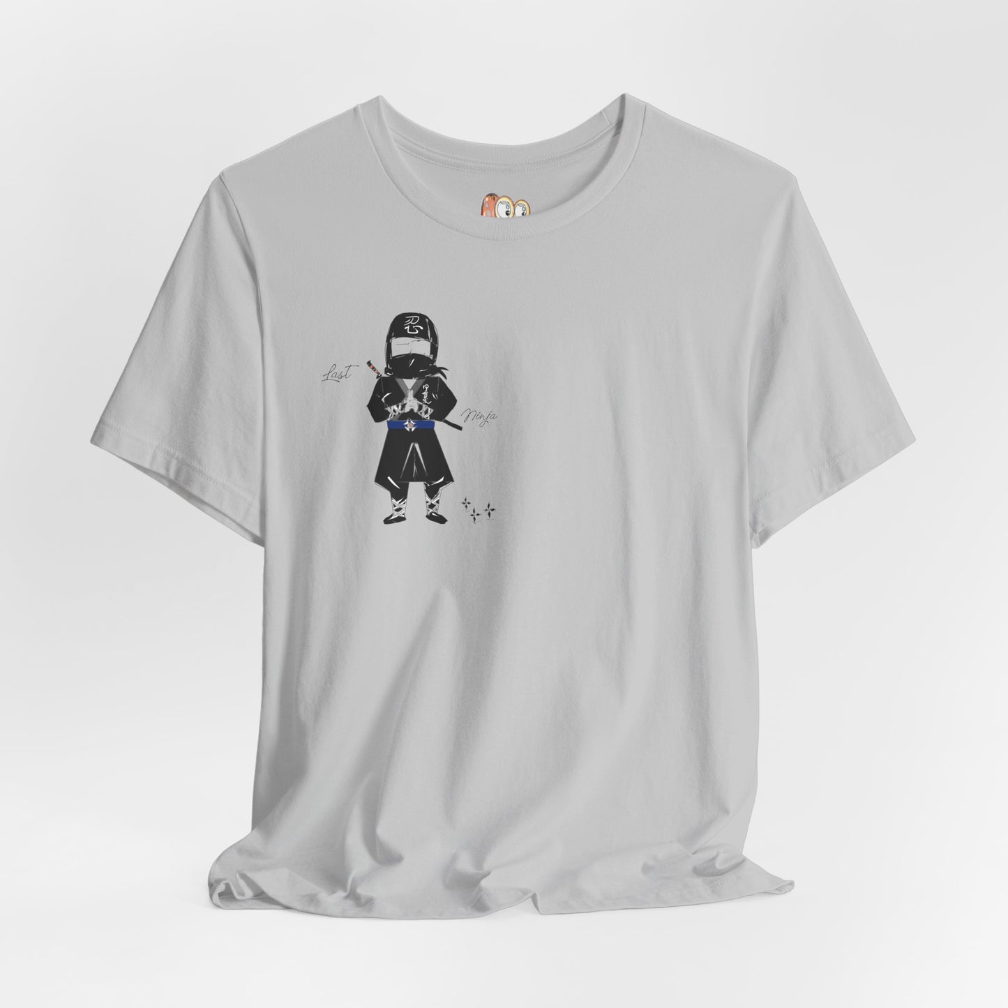 Gray t-shirt with a graphic of a playful ninja on a white background