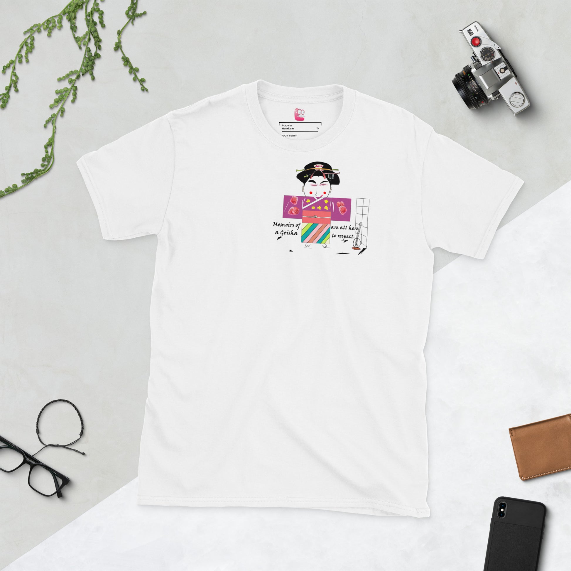 Front view of a white t-shirt with a Japanese Geisha graphic design on a background of desk