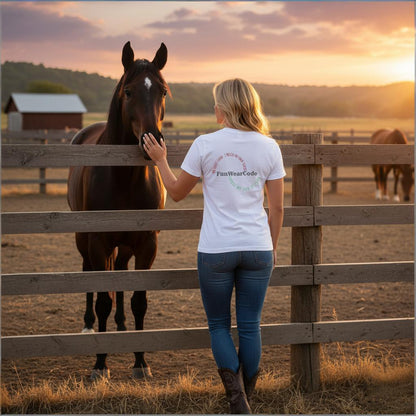 Woman petting a horse behind a wooden fence at sunset.
