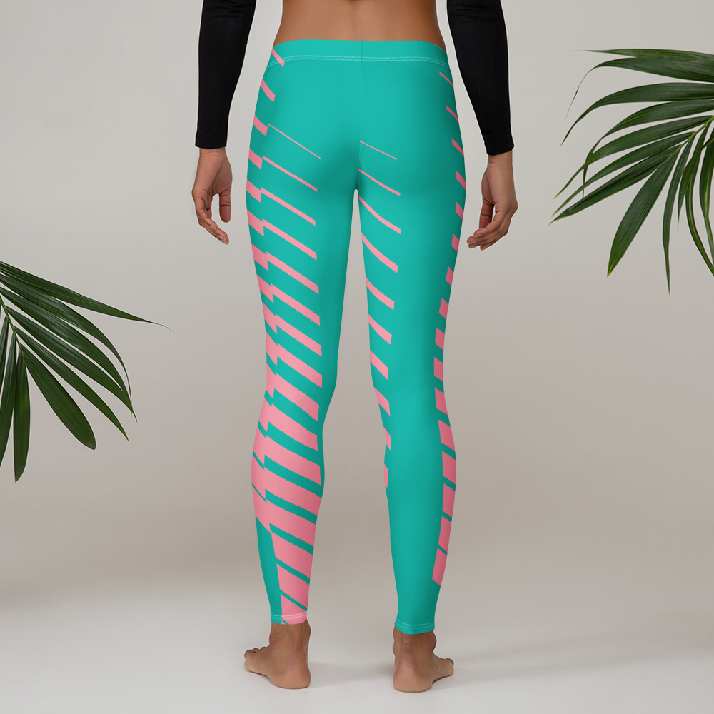 Teal and pink striped leggings worn by a person on a neutral background with green leaves.