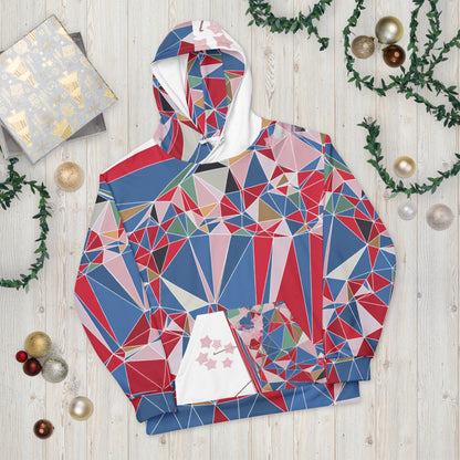 Colorful geometric-patterned hoodie on a wooden surface with Christmas decorations.
