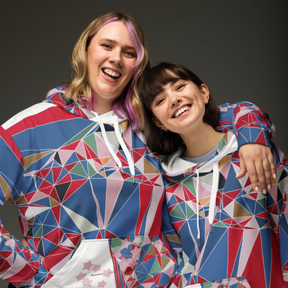 Two people wearing colorful geometric-patterned hoodies against a dark background