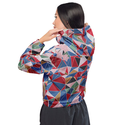 Woman wearing a colorful geometric-patterned jacket with spring cherry blossom graphic on a white background