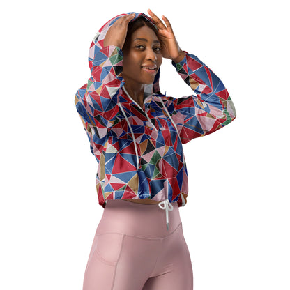 Woman wearing a colorful geometric-patterned windbreaker and pink leggings on a white background